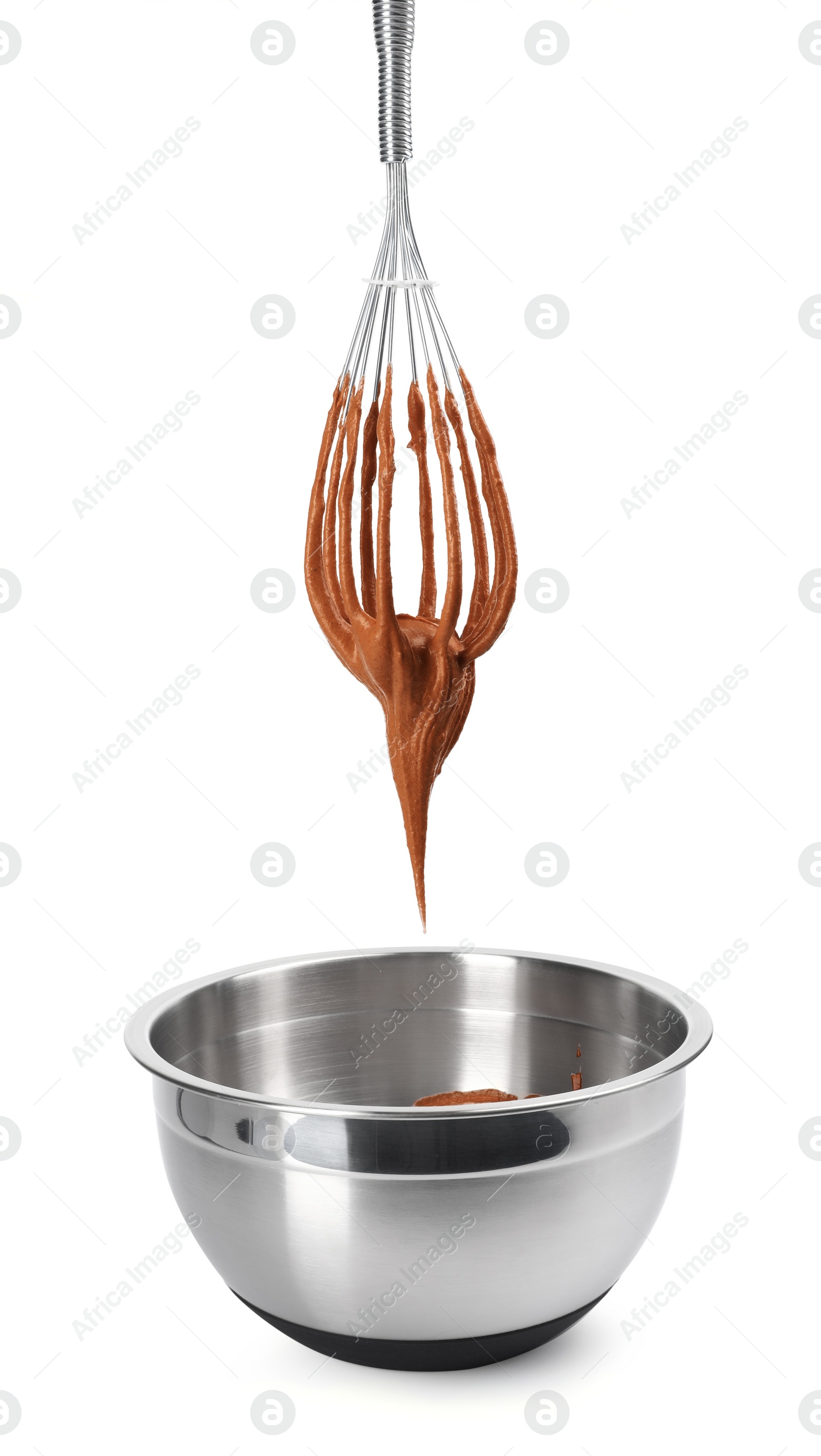 Photo of Chocolate cream flowing from whisk into bowl isolated on white