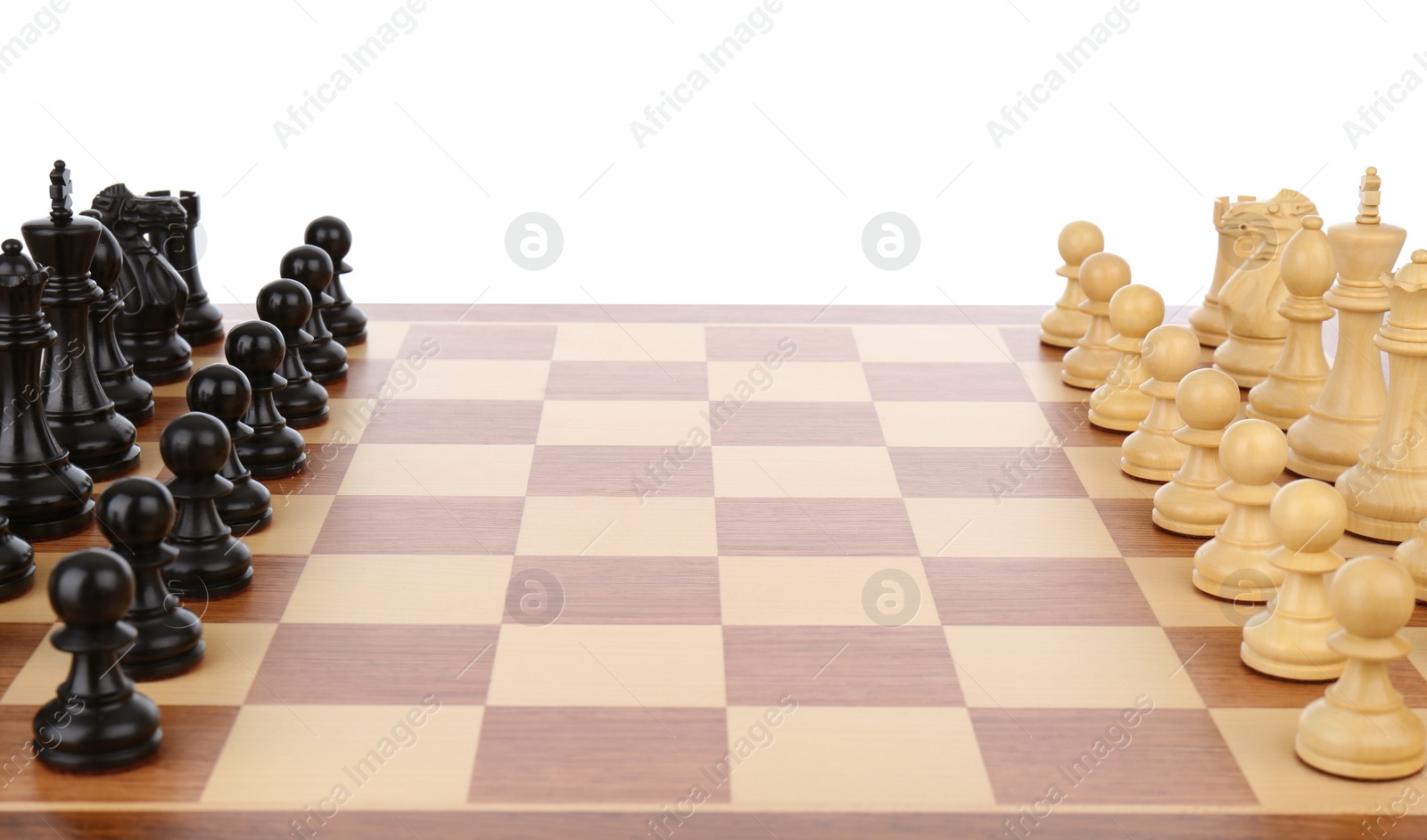 Photo of Chess pieces on wooden board against white background