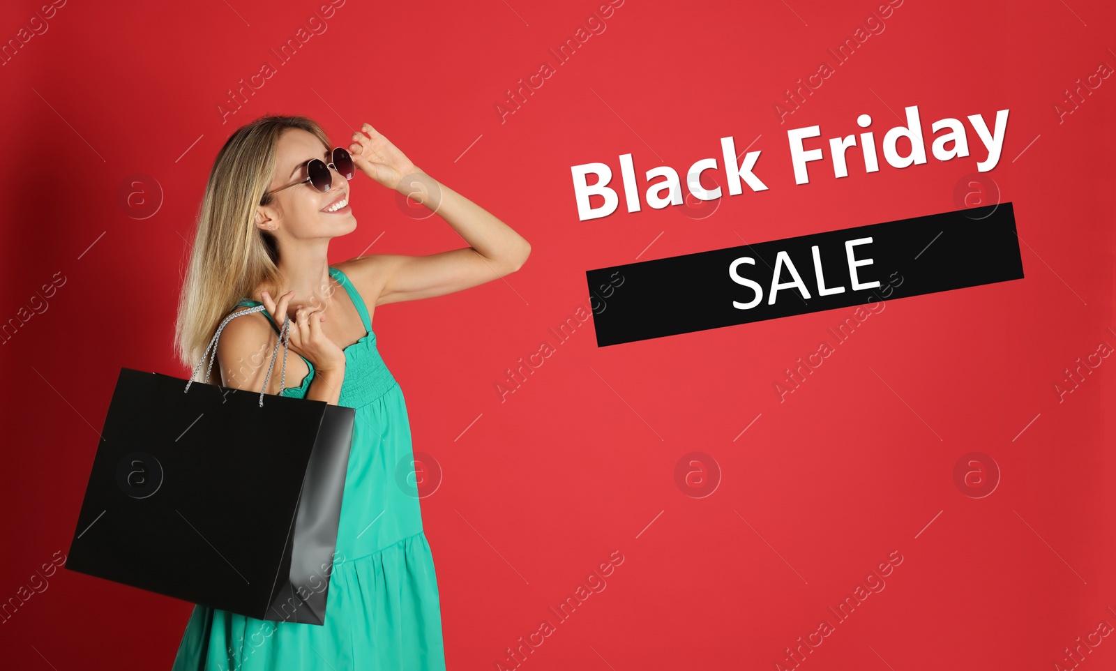 Image of Black Friday Sale. Beautiful young woman with shopping bags on red background
