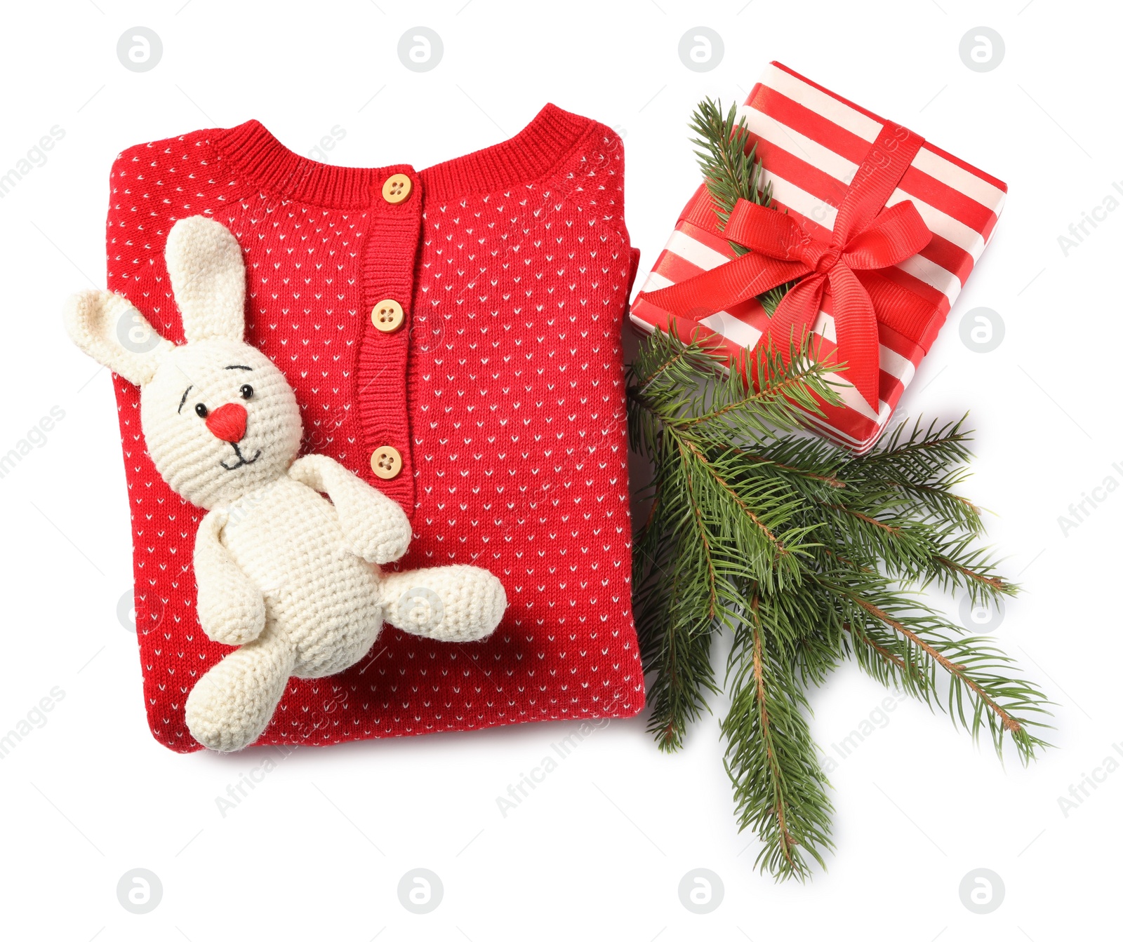 Photo of Red folded baby clothes and Christmas decorations on white background, top view