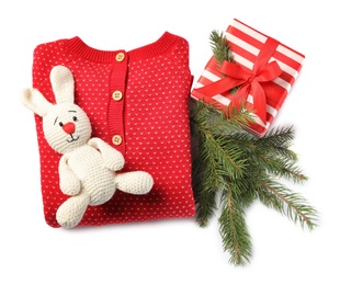 Photo of Red folded baby clothes and Christmas decorations on white background, top view