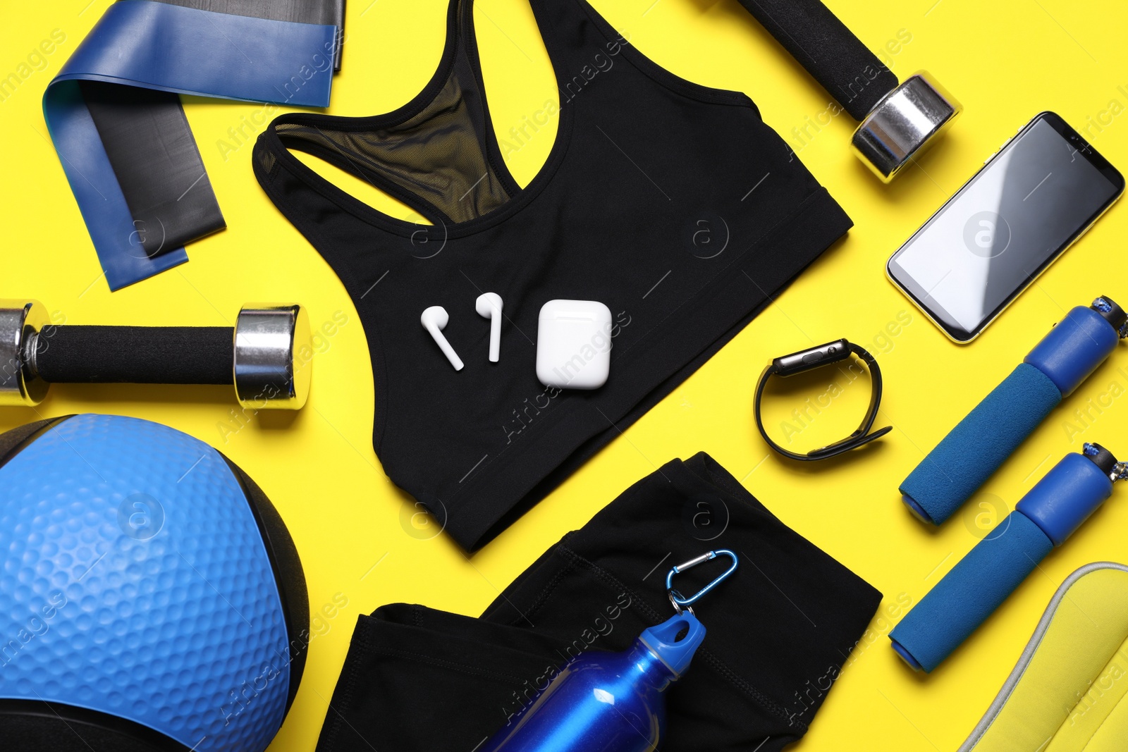 Photo of Flat lay composition with sports equipment on yellow background