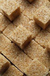 Photo of Brown sugar cubes as background, closeup view