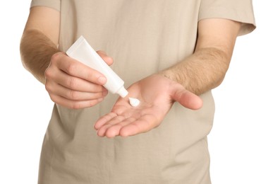 Photo of Man applying cream onto hand against white background, closeup