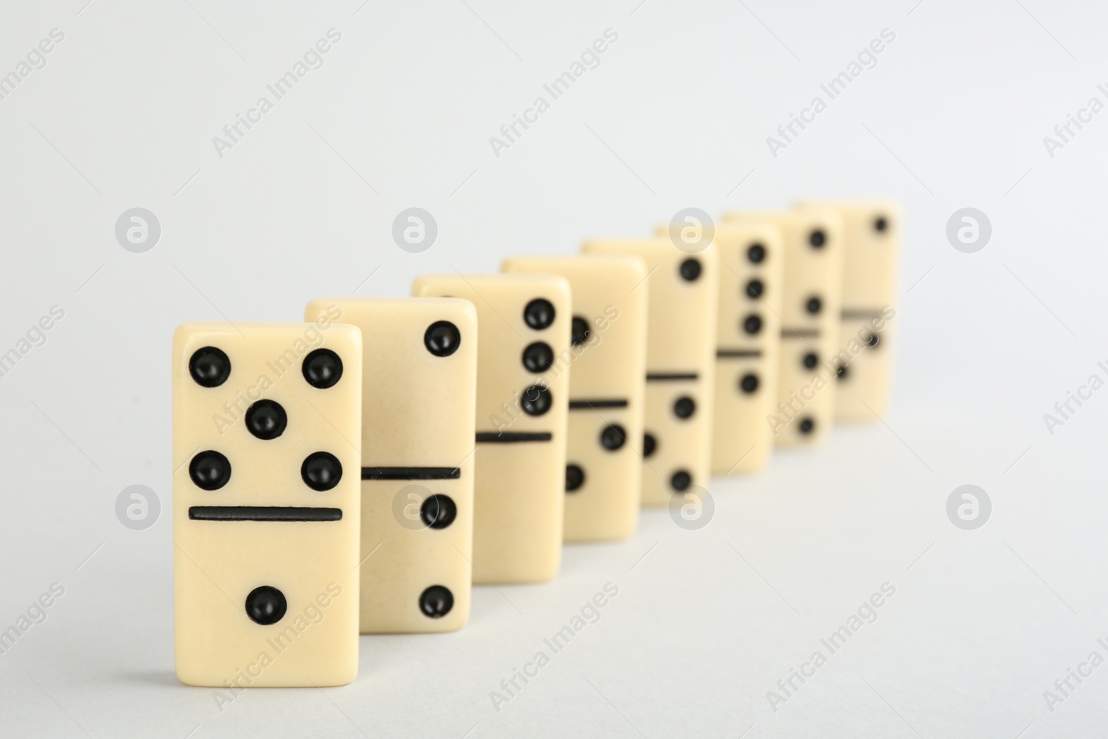 Photo of Row of domino tiles on white background
