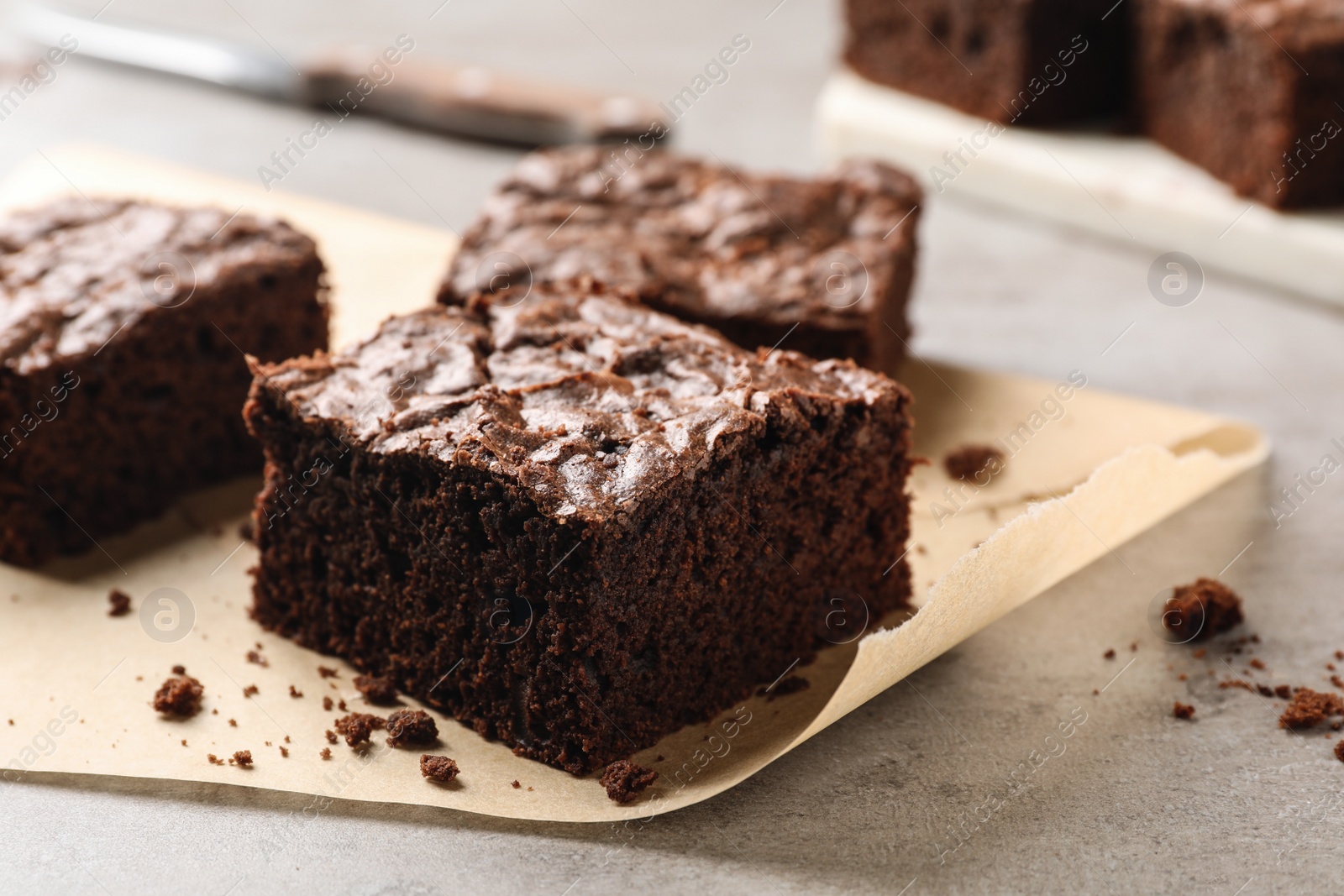 Photo of Fresh brownies on table, closeup with space for text. Delicious chocolate pie