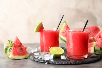 Photo of Tasty summer watermelon drink in glasses served on table