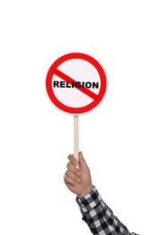 Image of Atheism concept. Man holding prohibition sign with crossed out word Religion on white background