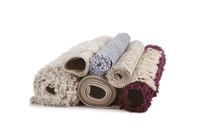 Different rolled carpets on white background. Interior element