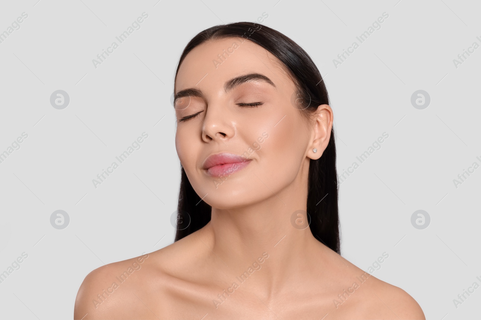 Photo of Portrait of attractive young woman on light grey background. Spa treatment