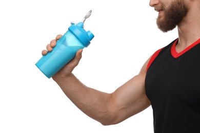 Young man with muscular body holding shaker of protein on white background, closeup