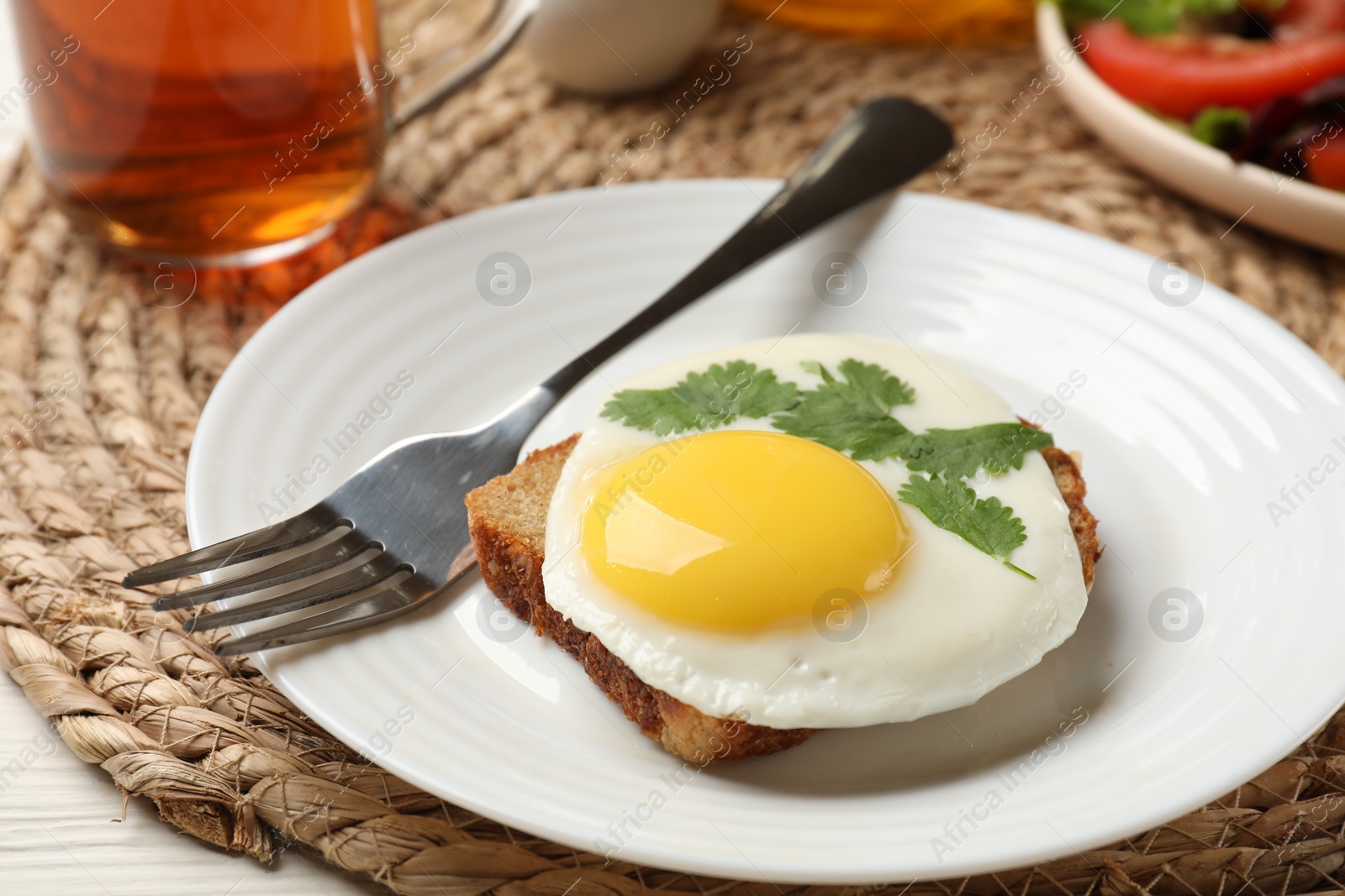 Photo of Delicious breakfast with fried egg served on table, closeup