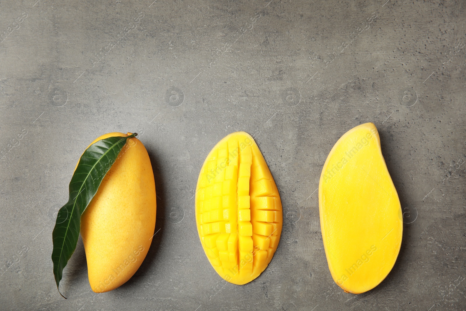 Photo of Flat lay composition with mango on grey background. Space for text