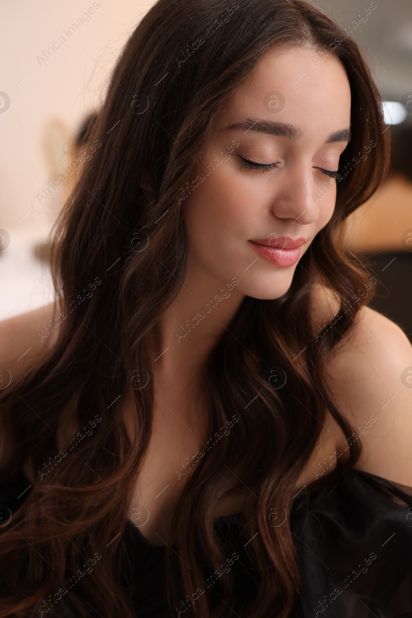 Photo of Portrait of beautiful woman with curly hair on blurred background