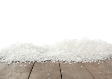 Photo of Snow on wooden surface against white background. Christmas season