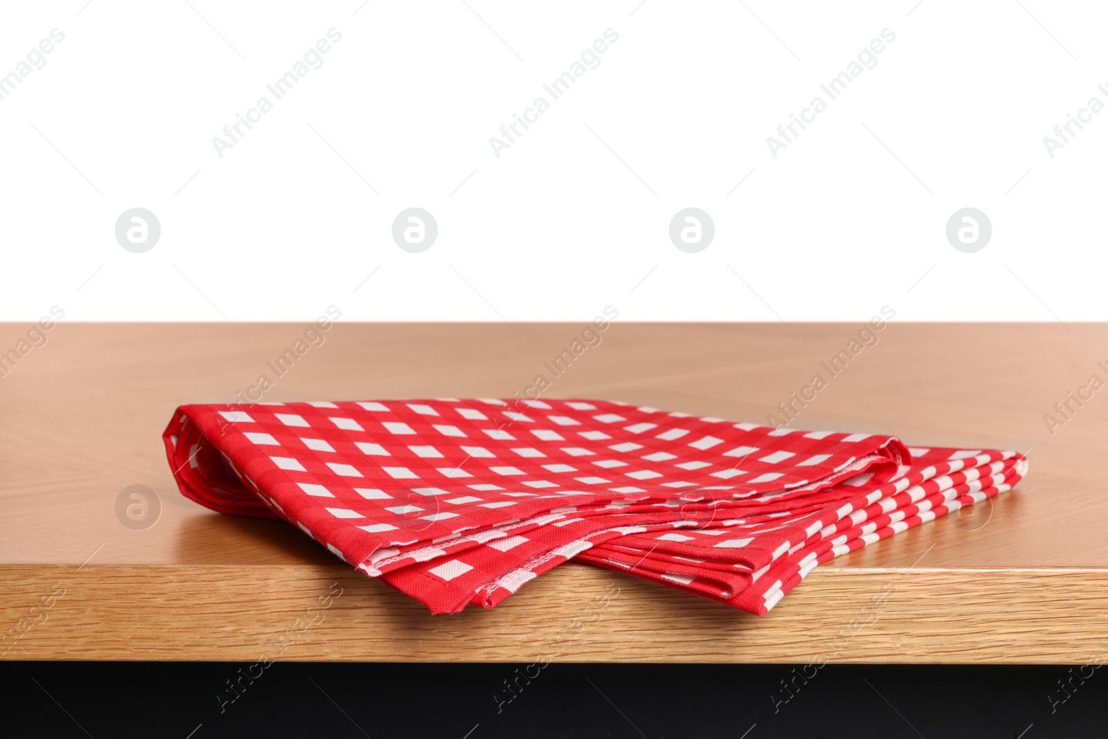 Photo of Checkered tablecloth on wooden table against white background