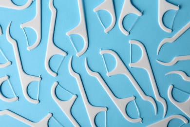 Photo of Many dental floss picks on color background, top view. Healthy teeth