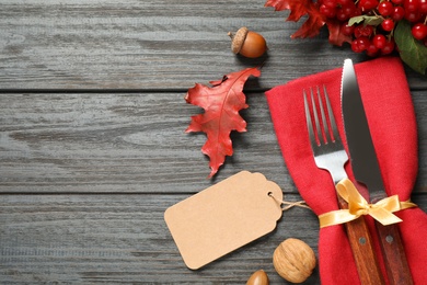 Flat lay composition with cutlery and autumn decoration on grey wooden background, space for text. Happy Thanksgiving day