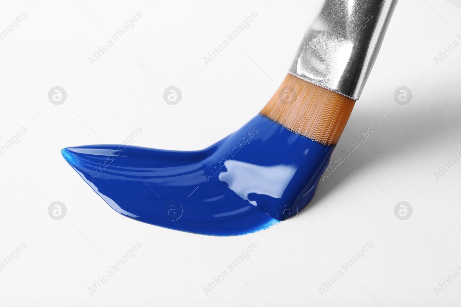 Photo of Brush with color paint and stroke on white background