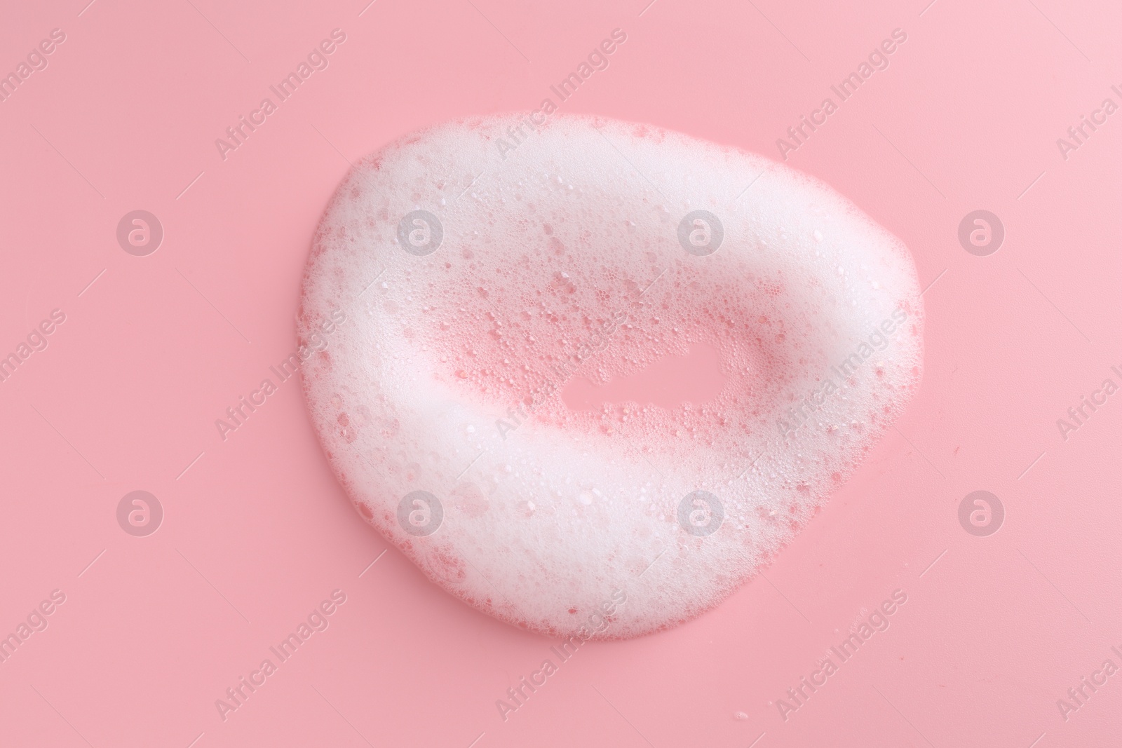 Photo of Sample of fluffy foam on pink background, top view