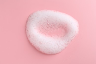 Sample of fluffy foam on pink background, top view