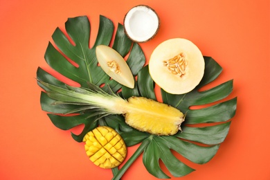 Flat lay composition with melon and other fruits on color background