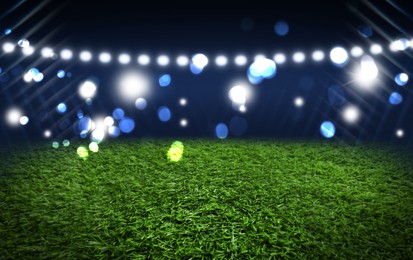 Image of Green sports field under stadium lights, bokeh effect. Banner design