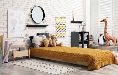 Photo of Montessori bedroom interior with floor bed and toys