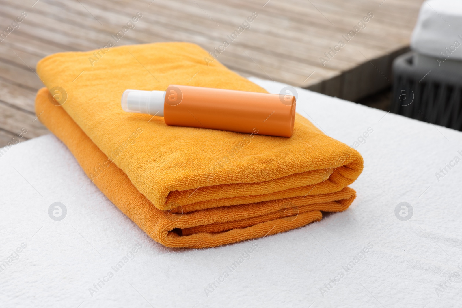 Photo of Beach towels and sunscreen on sunbed at resort