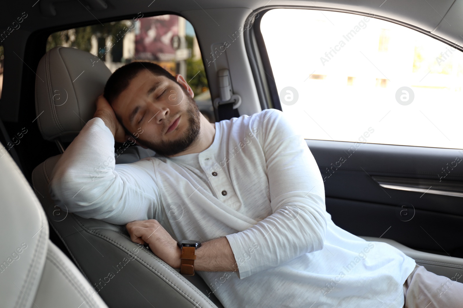 Photo of Tired man sleeping in his modern car