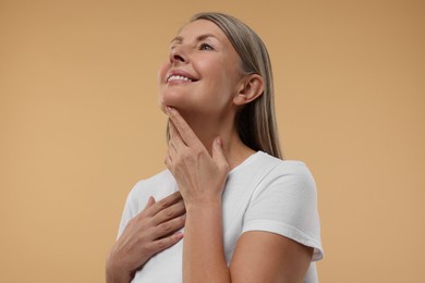 Photo of Beautiful woman with healthy skin on beige background