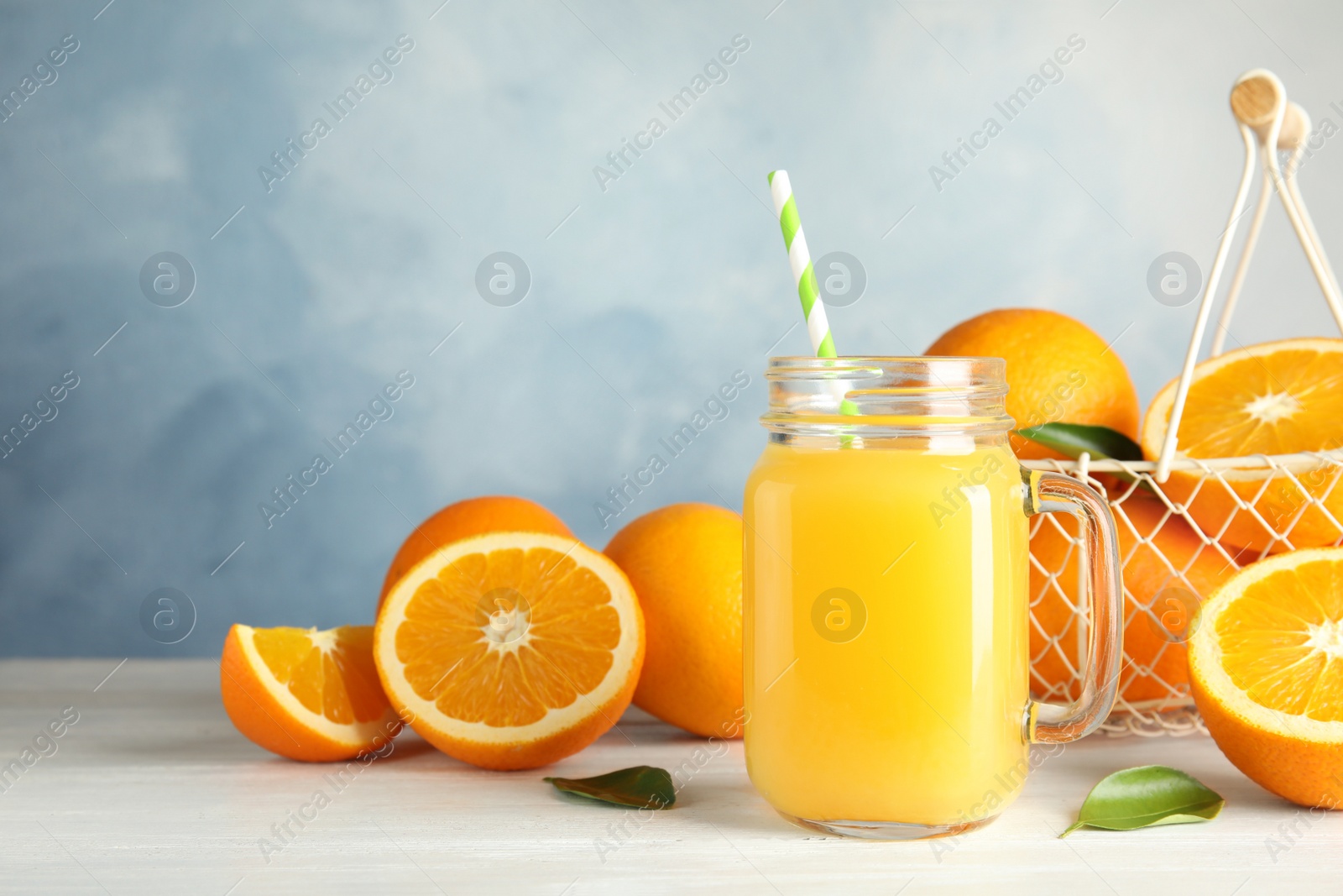 Photo of Composition with orange juice and fresh fruit on table. Space for text