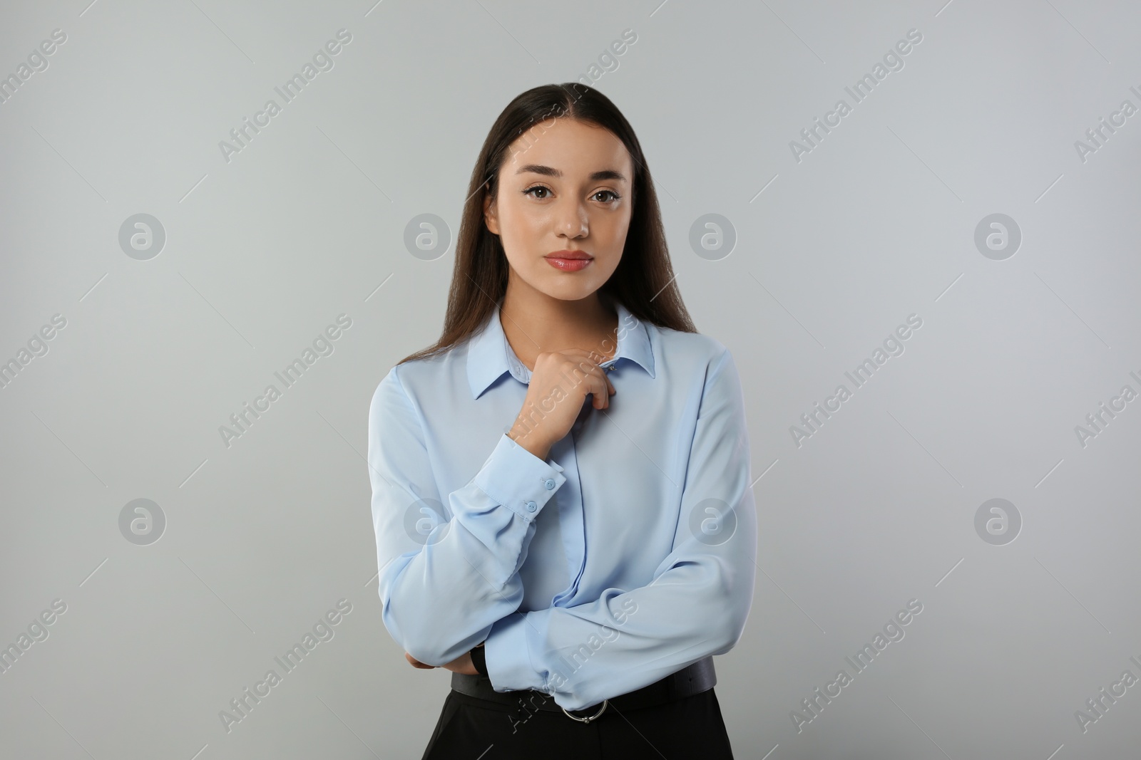 Photo of Portrait of beautiful young woman on light grey background