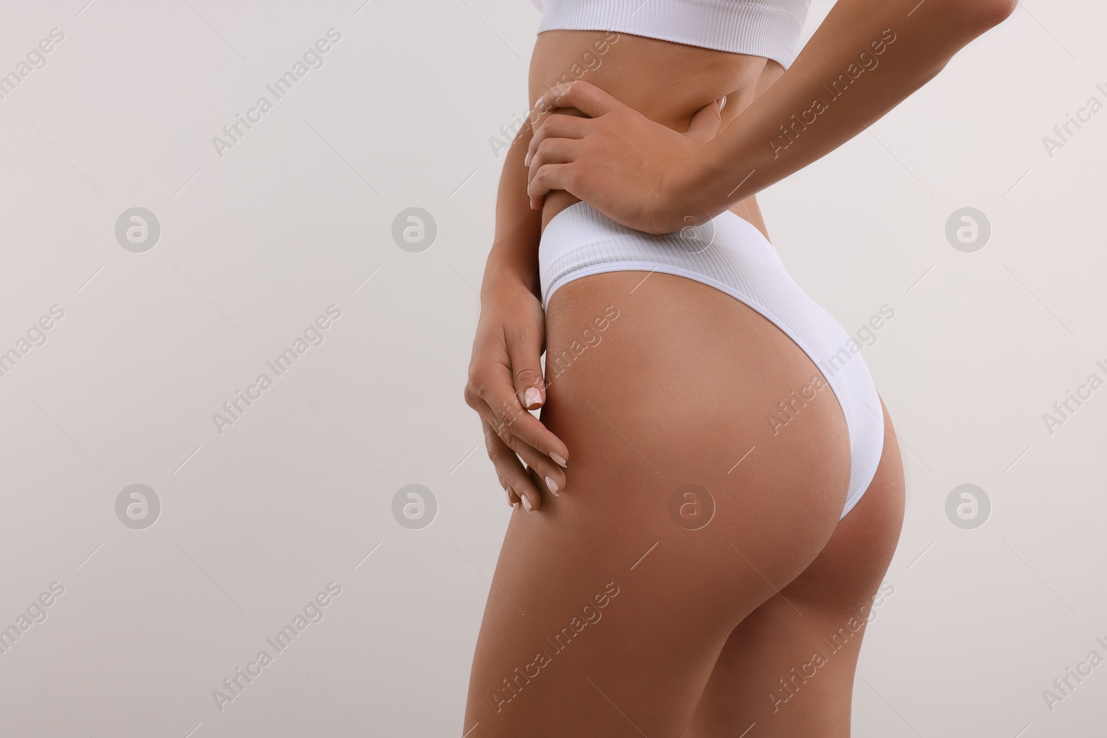 Photo of Young woman in stylish bikini on white background, closeup. Space for text