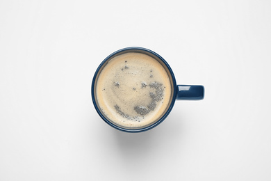 Photo of Coffee in cup on white background, top view. Color of the year 2020 (Classic blue)