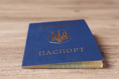 Ukrainian internal passport on wooden background, closeup