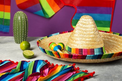 Photo of Composition with Mexican sombrero hat and maracas on grey table