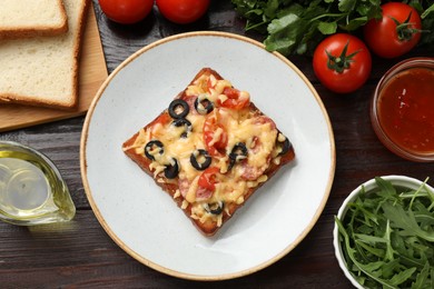 Photo of Tasty pizza toast and ingredients on wooden table, flat lay