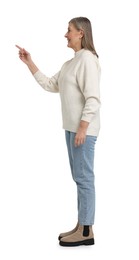 Photo of Senior woman pointing at something on white background
