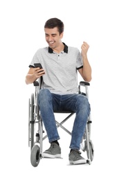 Photo of Emotional man in wheelchair using mobile phone isolated on white