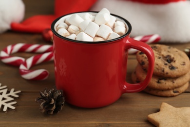 Photo of Composition with delicious marshmallow cocoa on wooden table