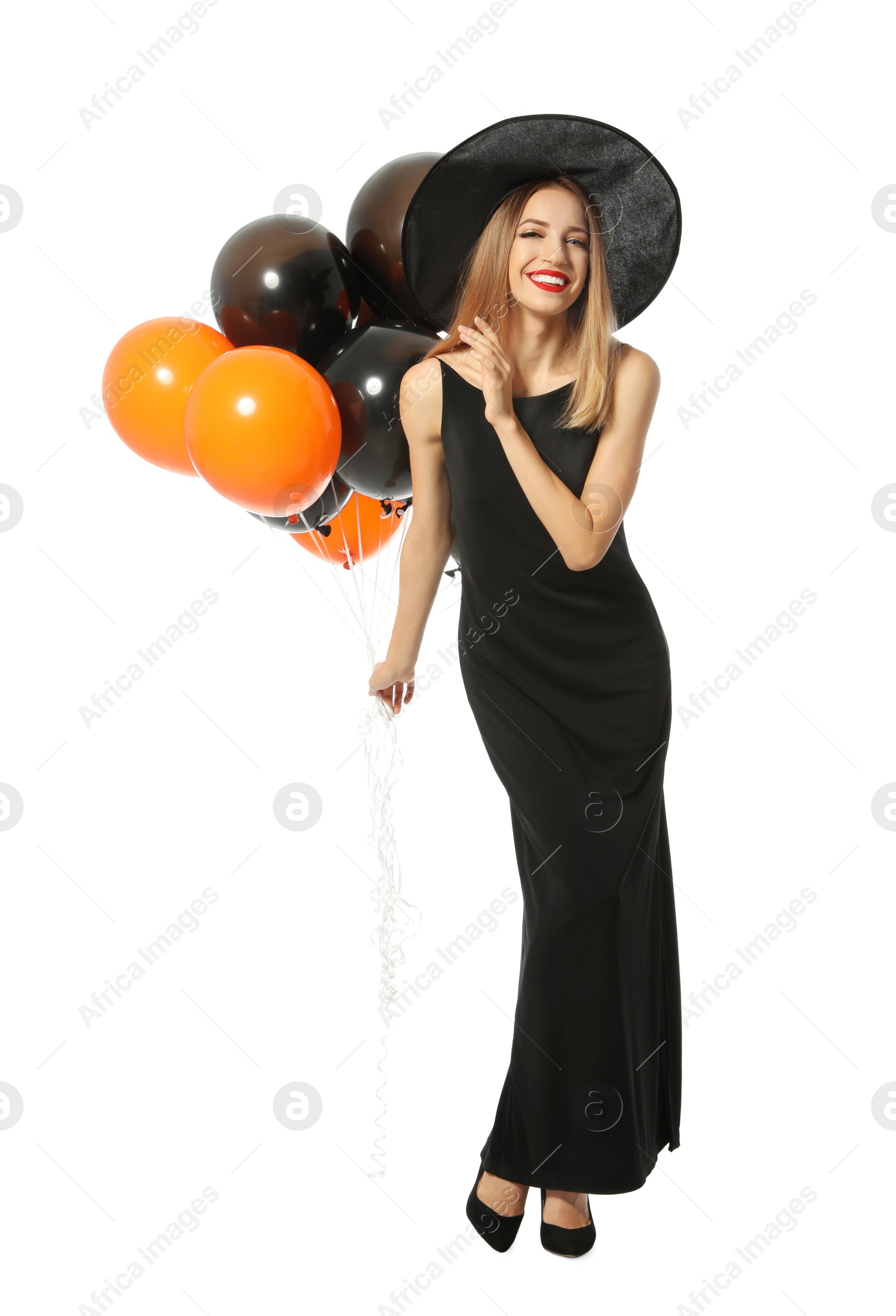 Photo of Beautiful woman wearing witch costume with balloons for Halloween party on white background