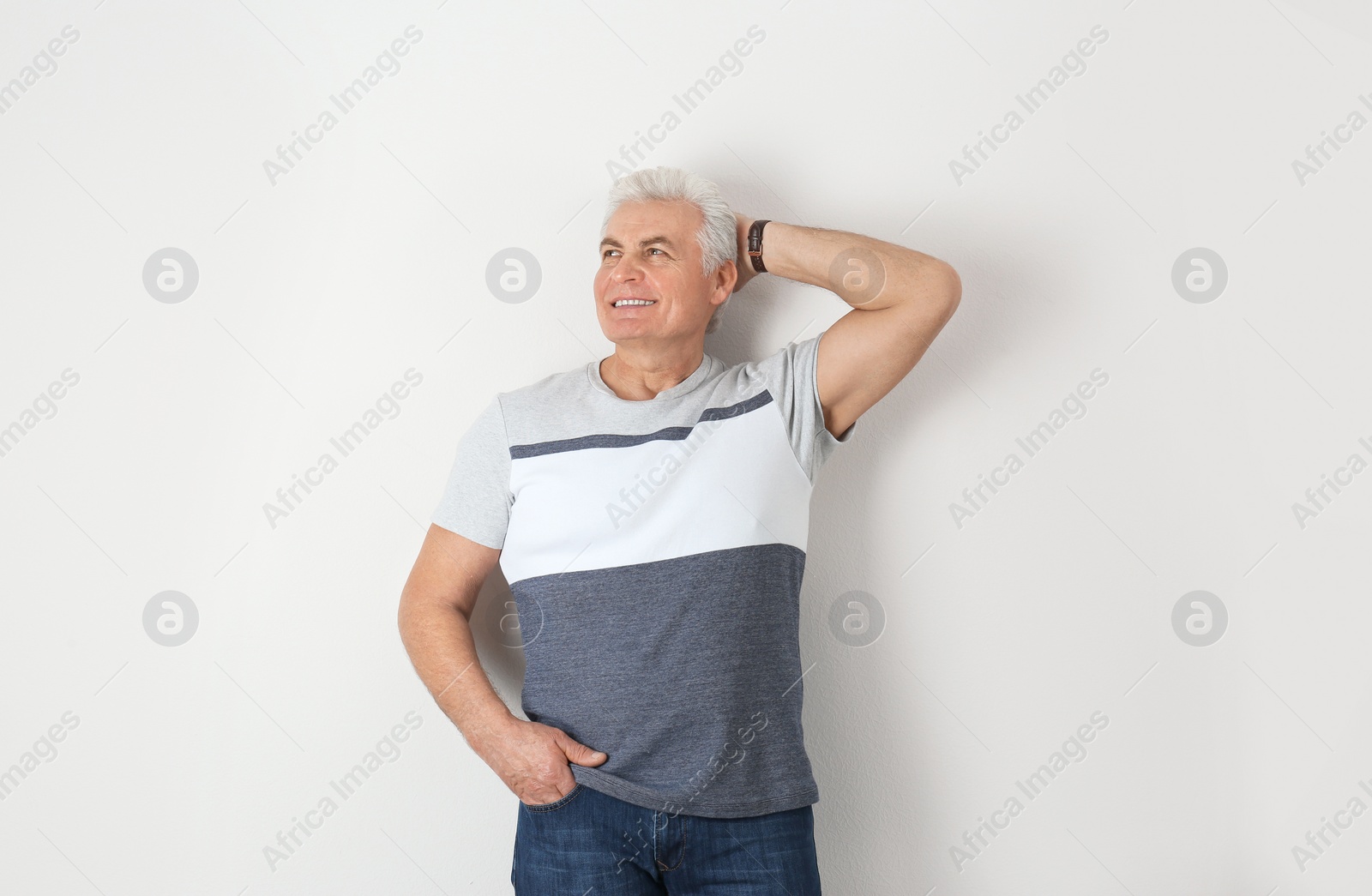 Photo of Portrait of handsome mature man on light background