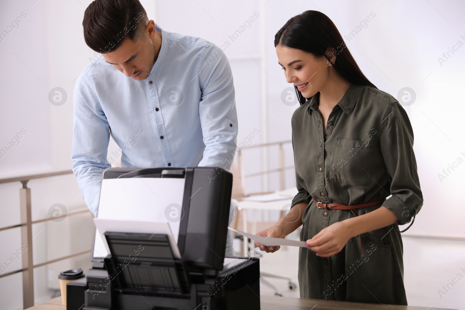 Photo of Employees using new modern printer in office