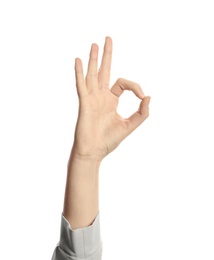 Photo of Young woman showing OK gesture on white background