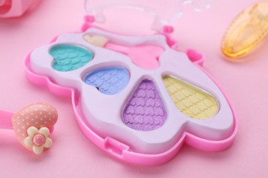 Photo of Decorative cosmetics for kids. Eye shadow palette on pink background, closeup