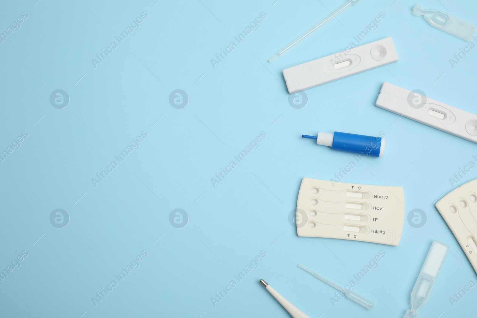 Photo of Disposable express hepatitis test kit on light blue background, flat lay. Space for text