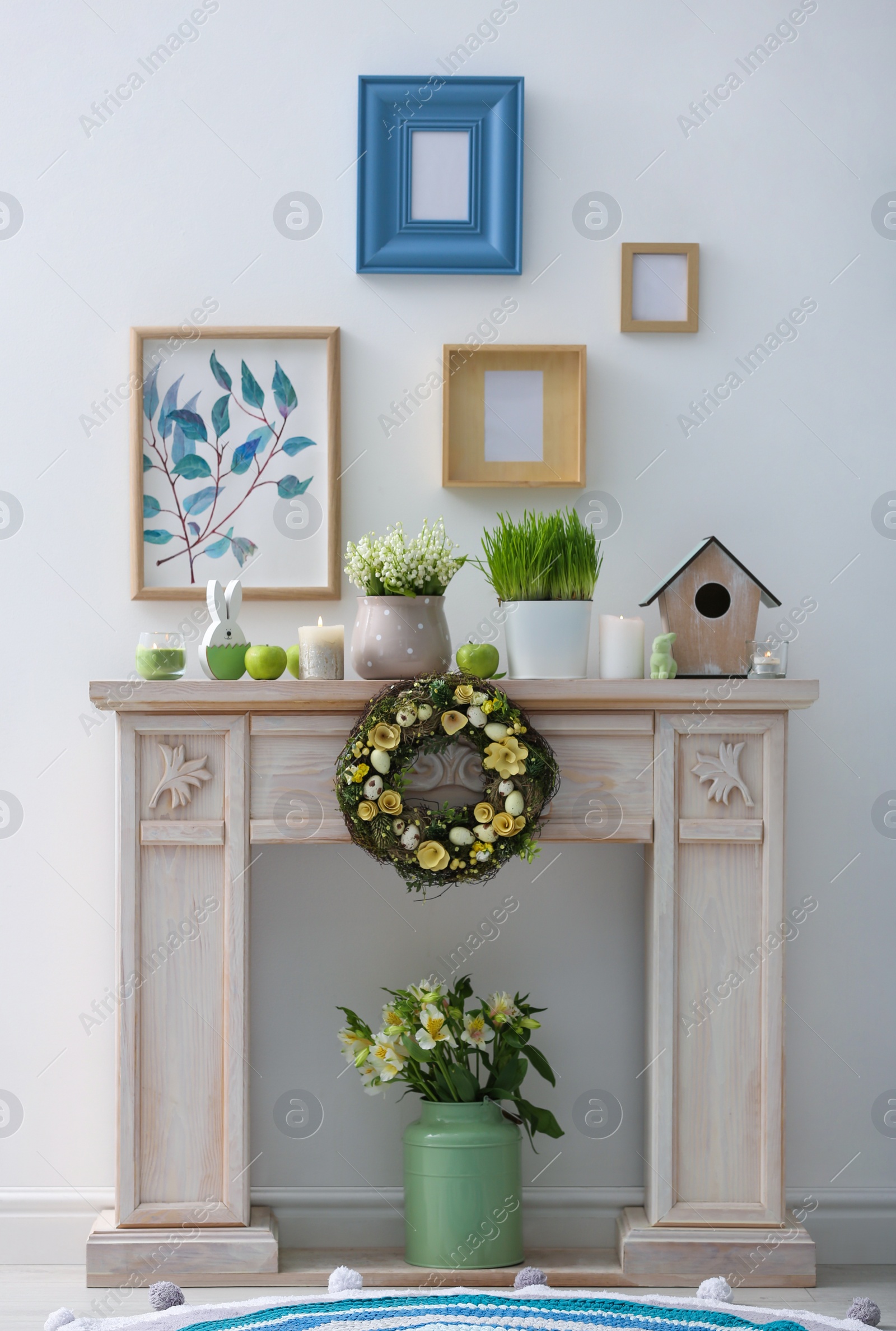 Photo of Decorative fireplace with beautiful spring decor indoors. Interior design