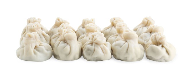 Photo of Many tasty khinkali (dumplings) isolated on white. Georgian cuisine