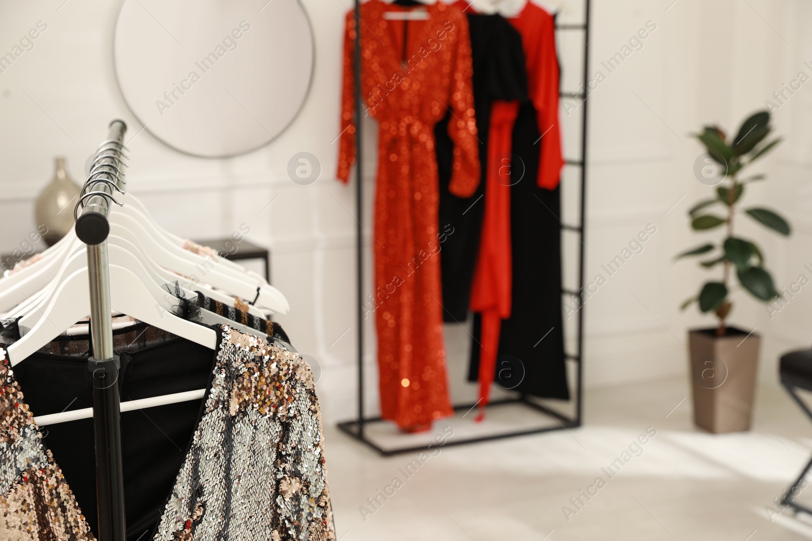 Photo of Collection of trendy women's garments in clothing rental salon, closeup and space for text